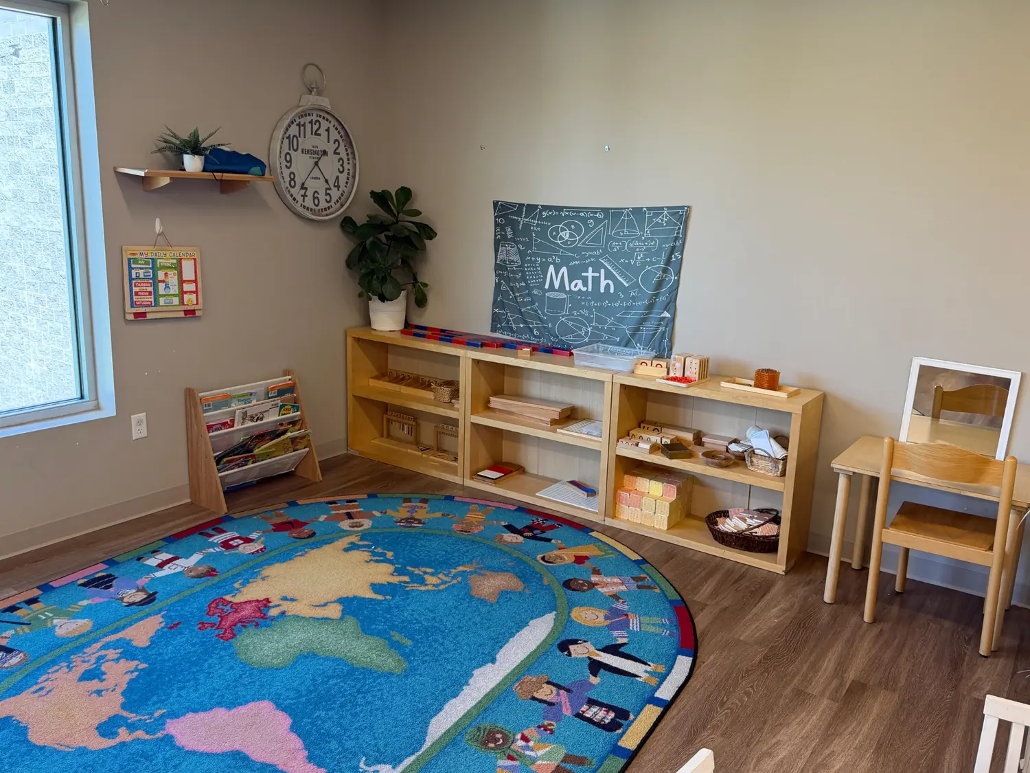 Prepared Montessori classroom with world map rug