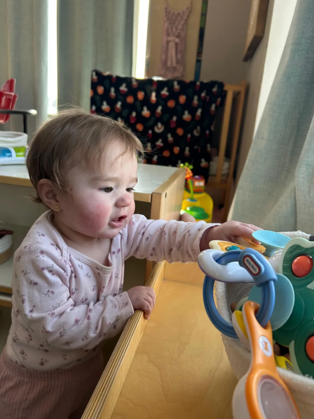 Young child exploring infant classroom materials